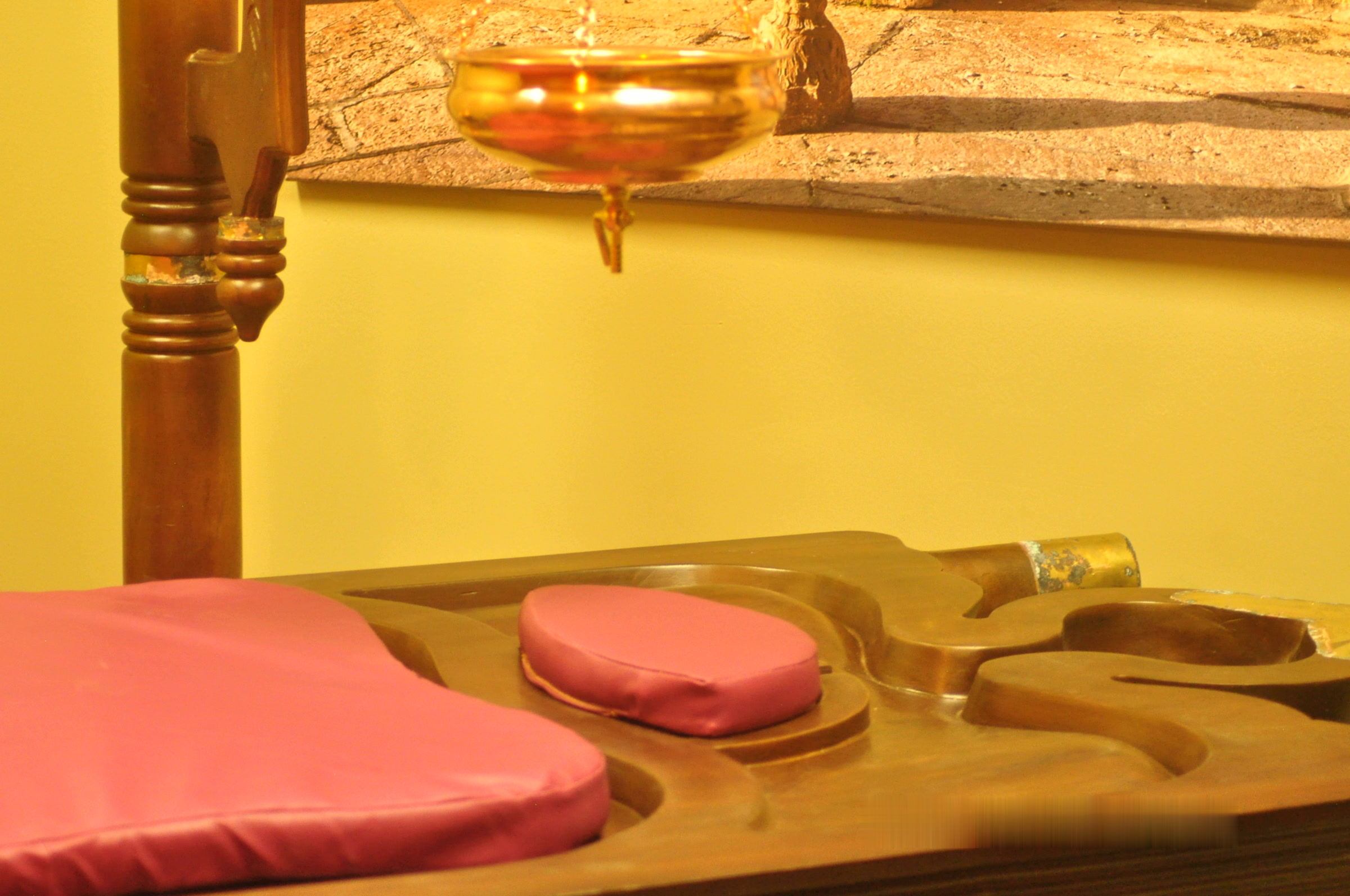 Our traditional medicated wood Shirodhara table, handcrafted in India